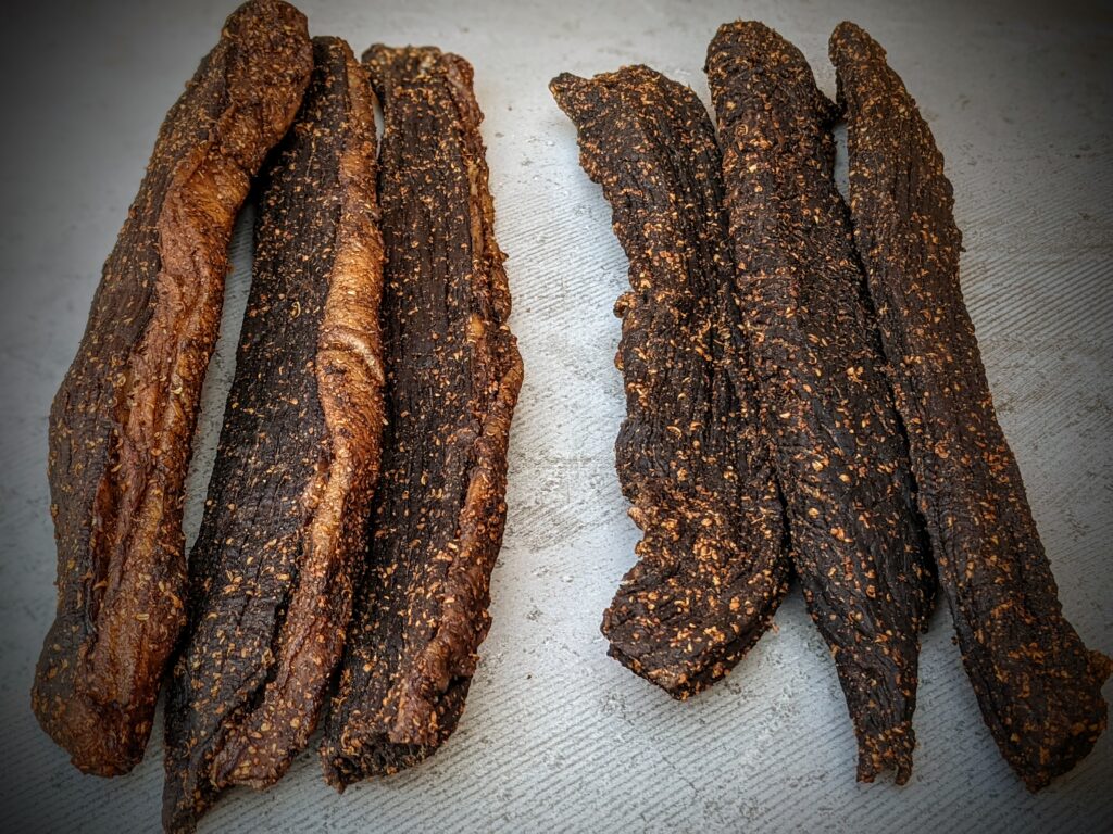 Whole pieces of wet and dry biltong showing different moisture levels